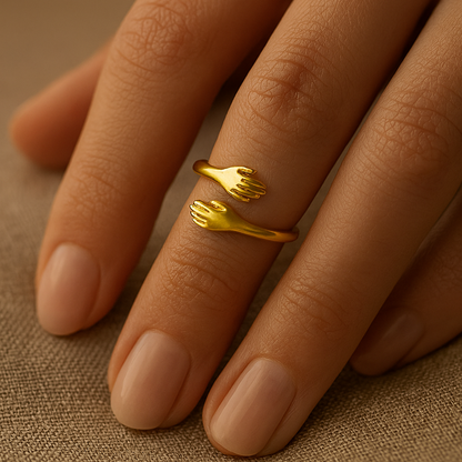 Gold ring with a unique design on a person's finger against a brown background